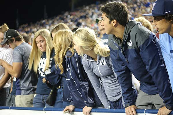 first row of a sport stadium with fans watching a game